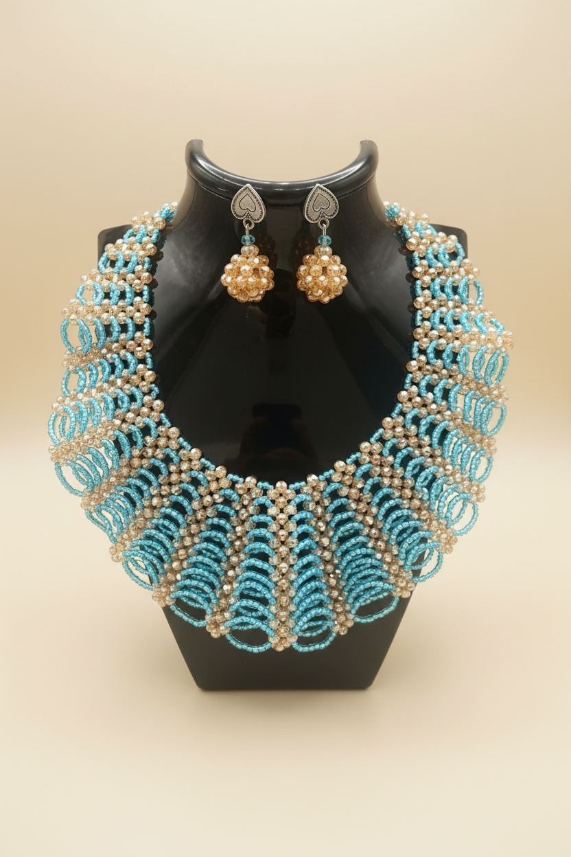 Handmade turquoise and gold beaded necklace set on cream background