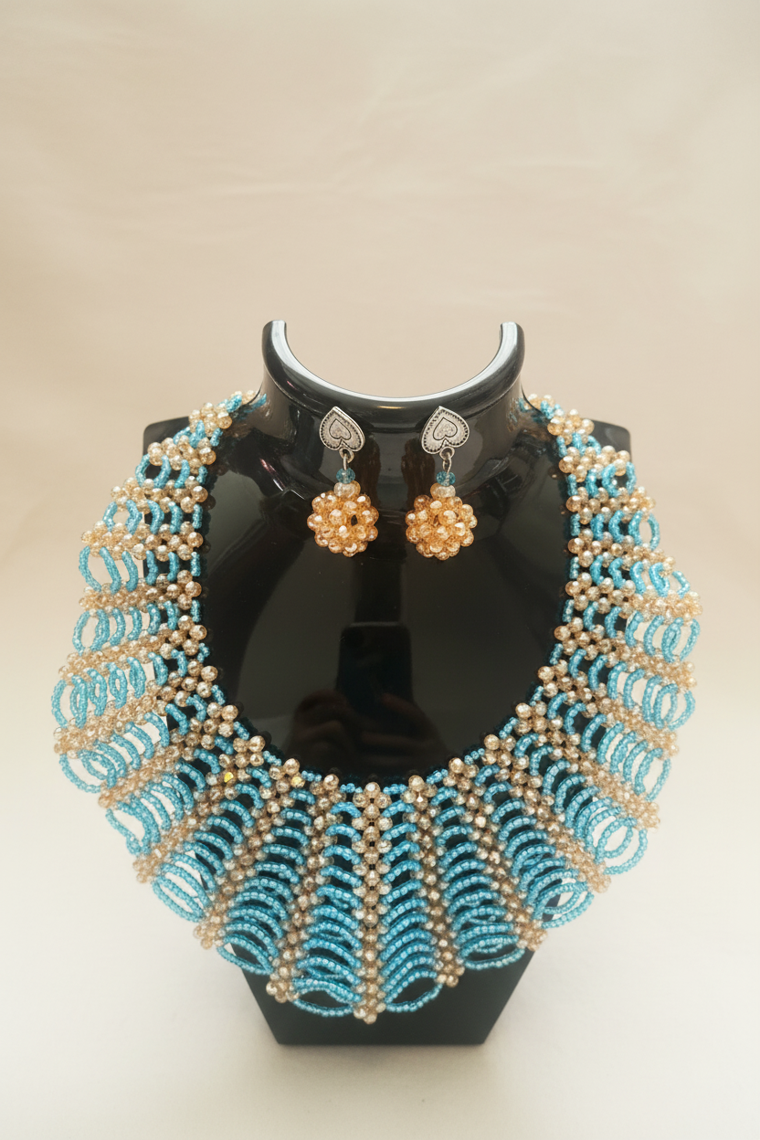 Handmade turquoise and gold beaded necklace set on cream background