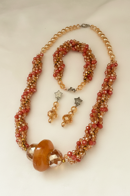 Handmade twisted crystal necklace set flat lay on cream background