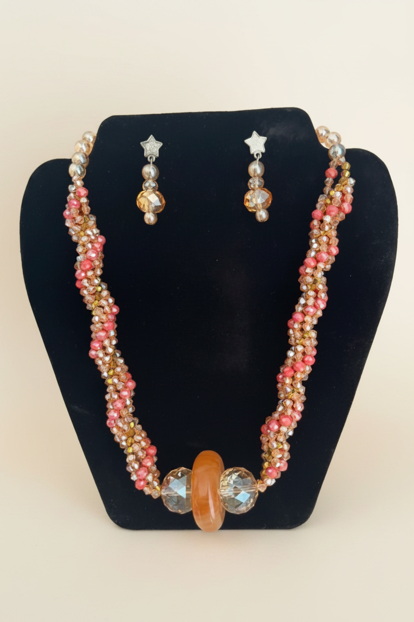Handmade twisted crystal necklace set on bust display on cream background
